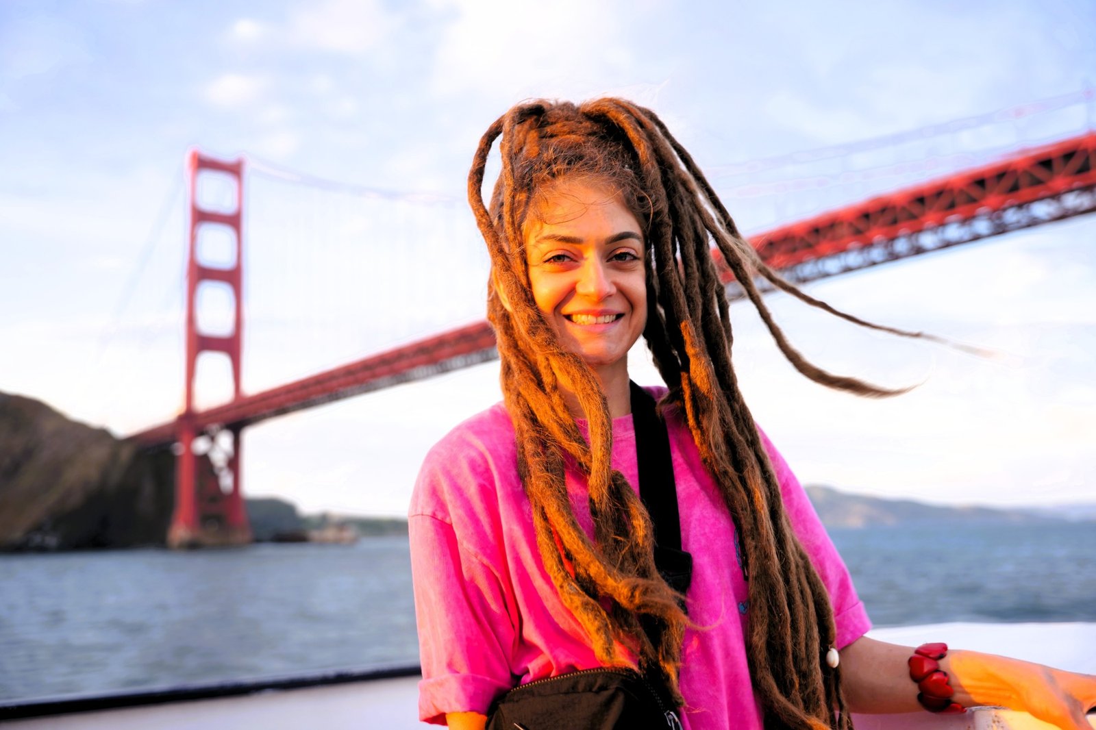 Christina smiling in front of the Golden Gate Bridge