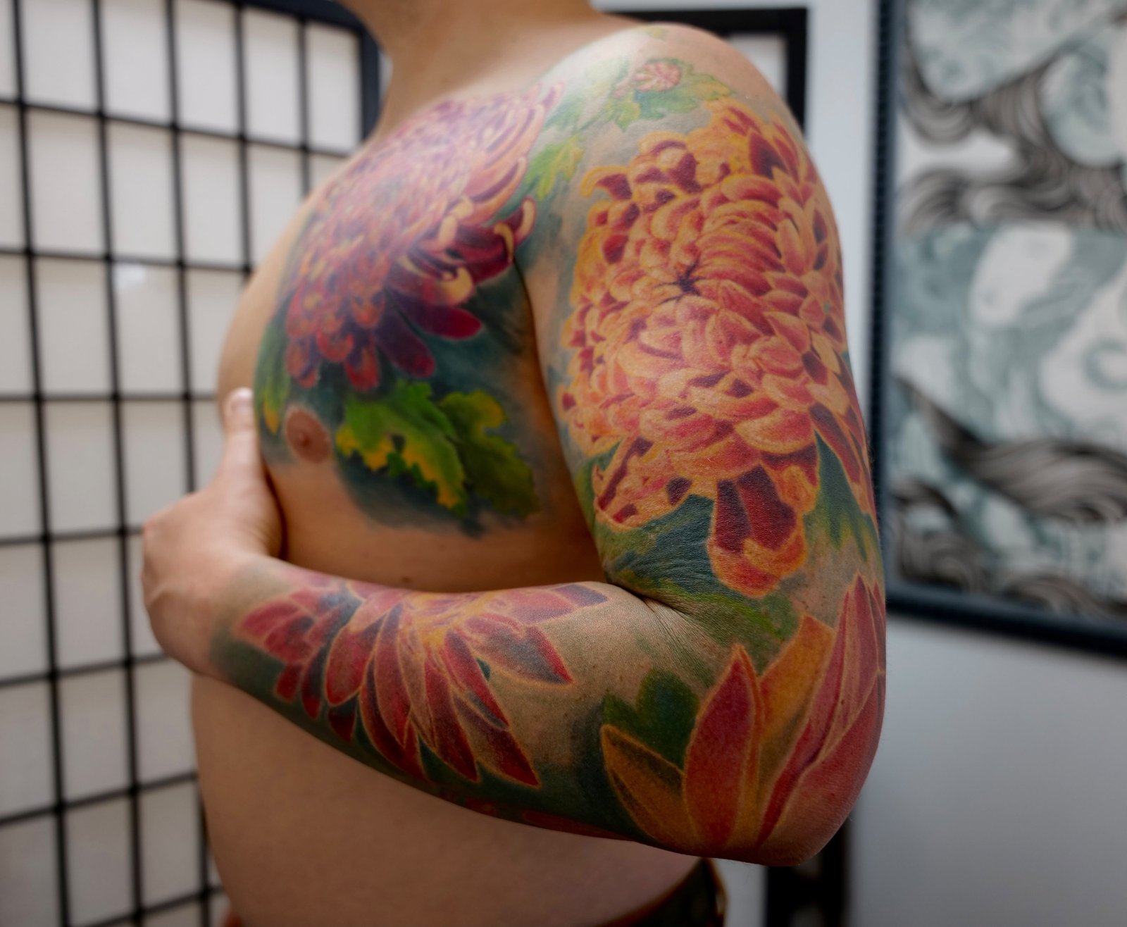 Chrysanthemum chest and sleeve tattoo in color realism without outlines