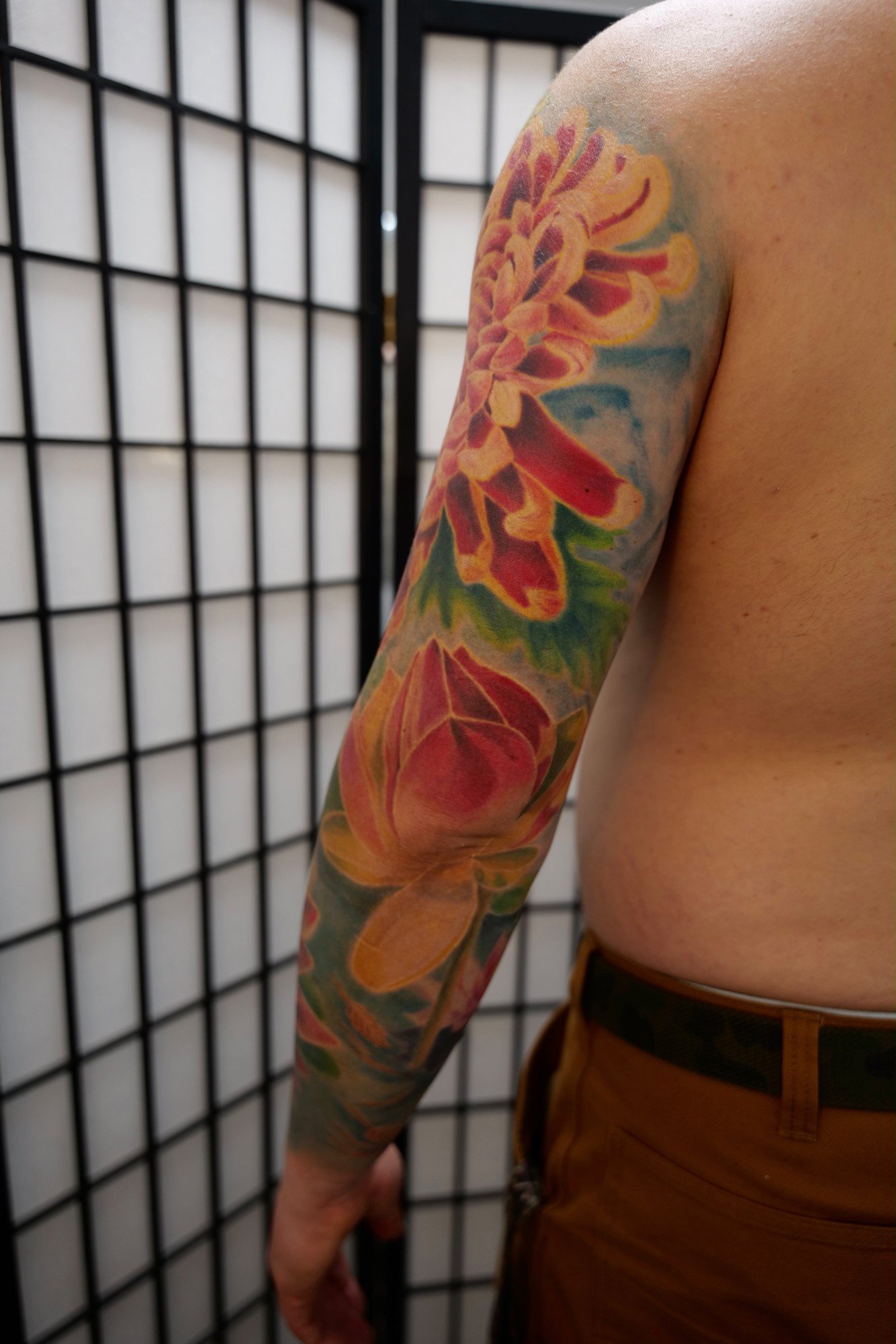 Color realism chrysanthemum and lotus sleeve tattoo with no black outlines, Berkeley